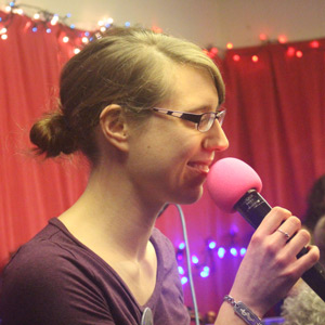Charlie Turner on stage holding a microphone