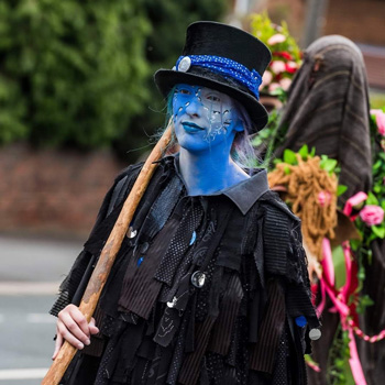 Abigail wearing Boggarts Breakfast kit with blue facepaint and hat, and with stick in hand